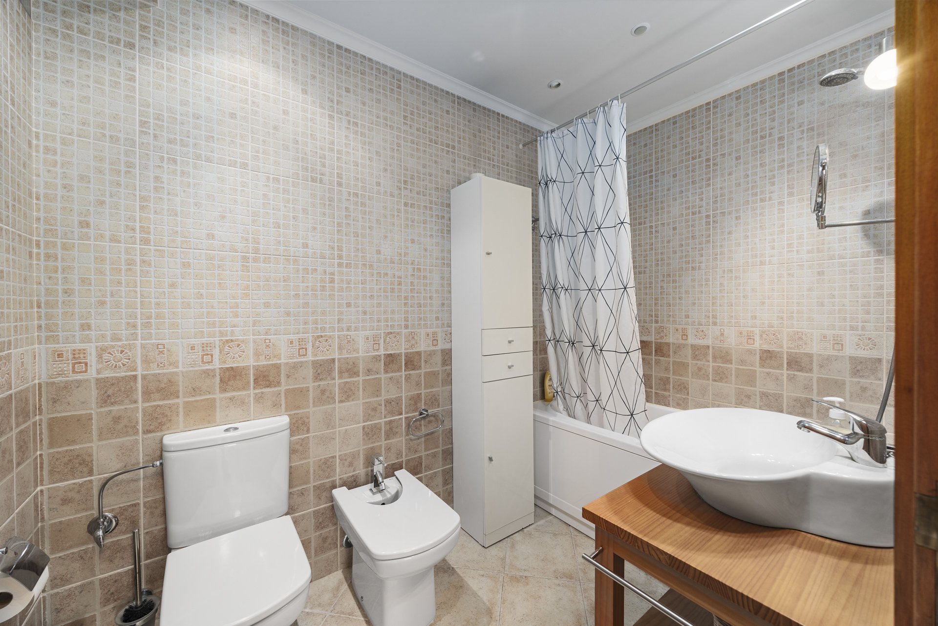 Bathroom with corner bathtub and bidet
