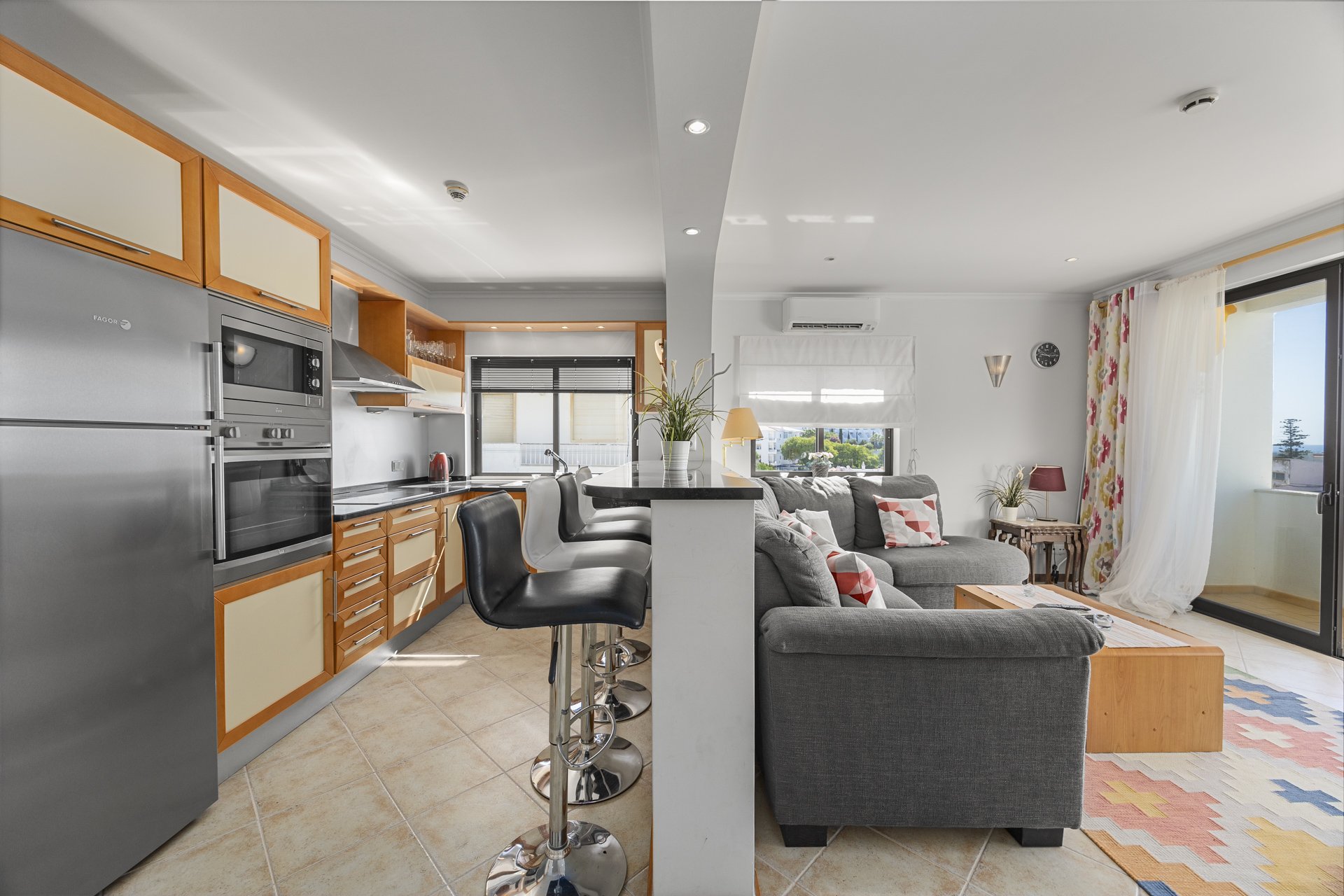 Kitchen with stainless steel appliances and breakfast bar, alternate view