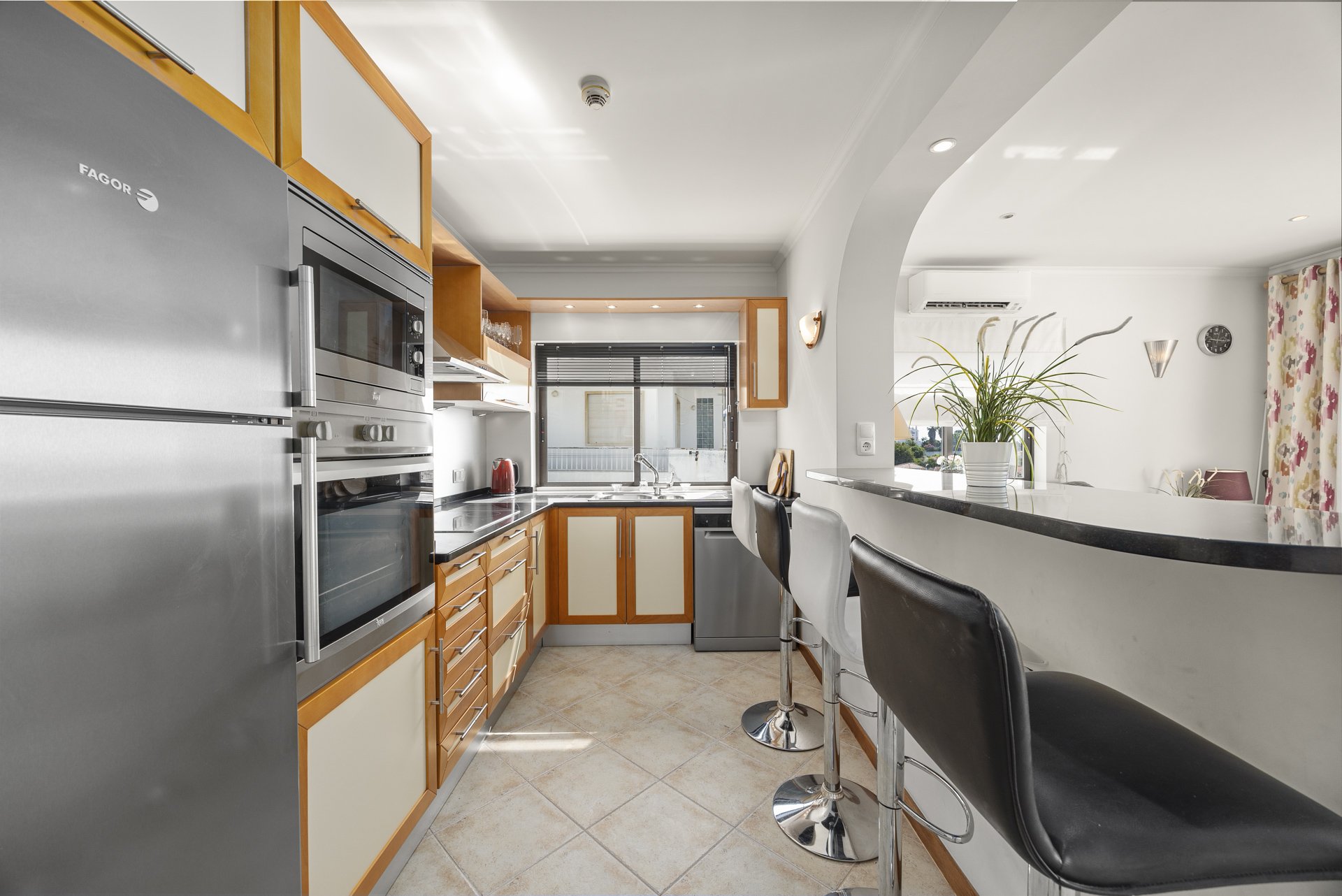 Kitchen with breakfast bar opening onto the living room