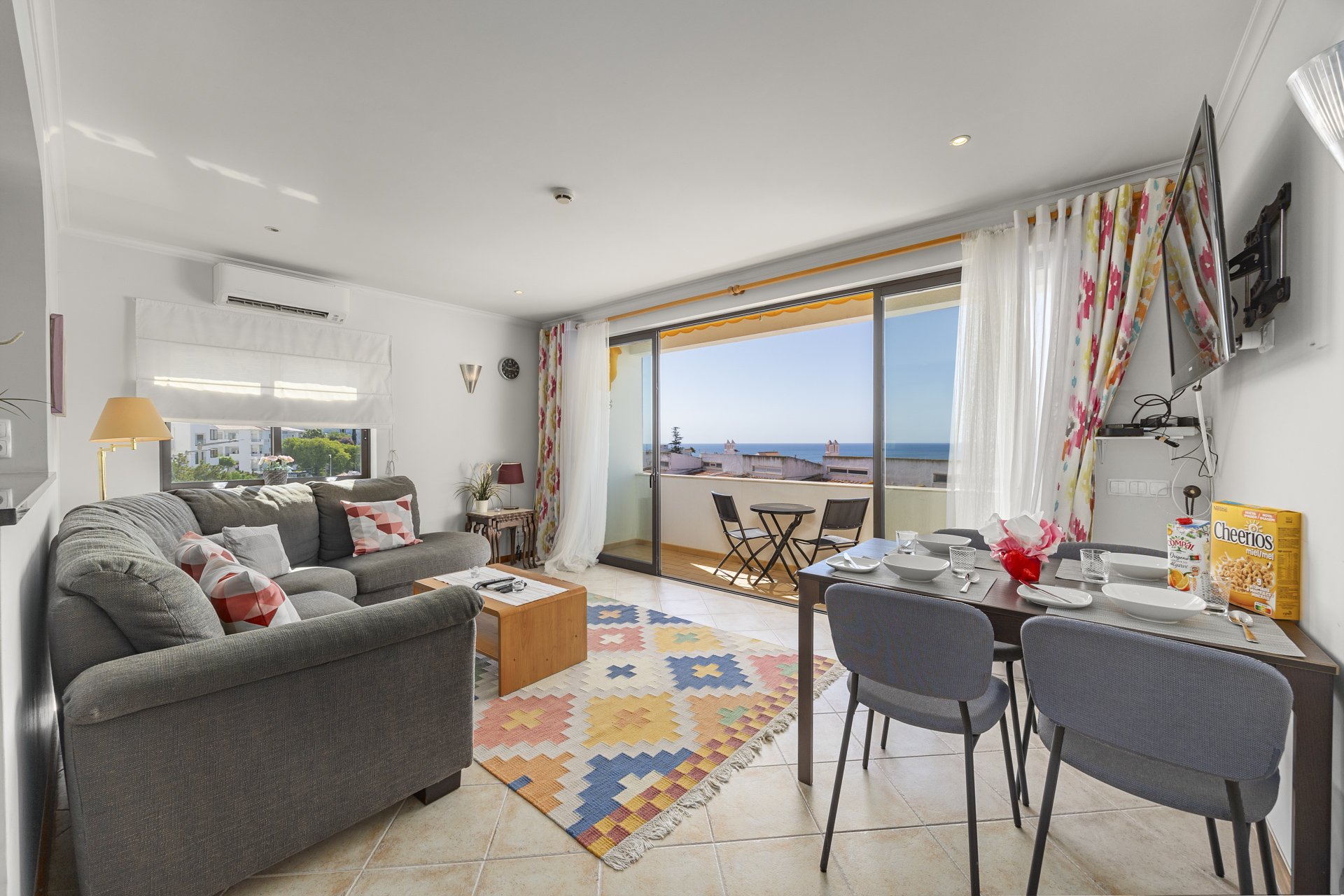 Living and dining area with balcony access and sea view