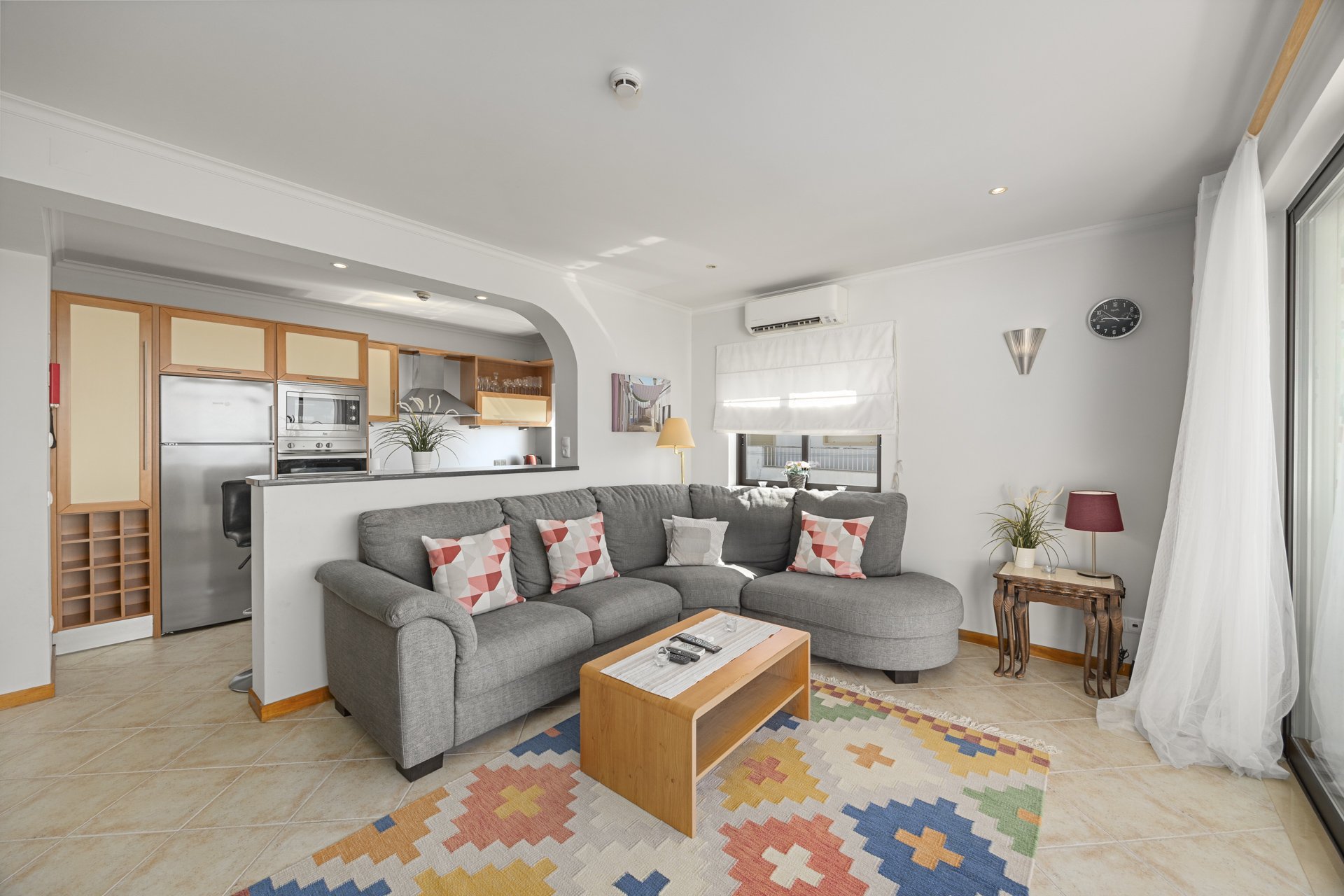 Living room with kitchen visible through archway