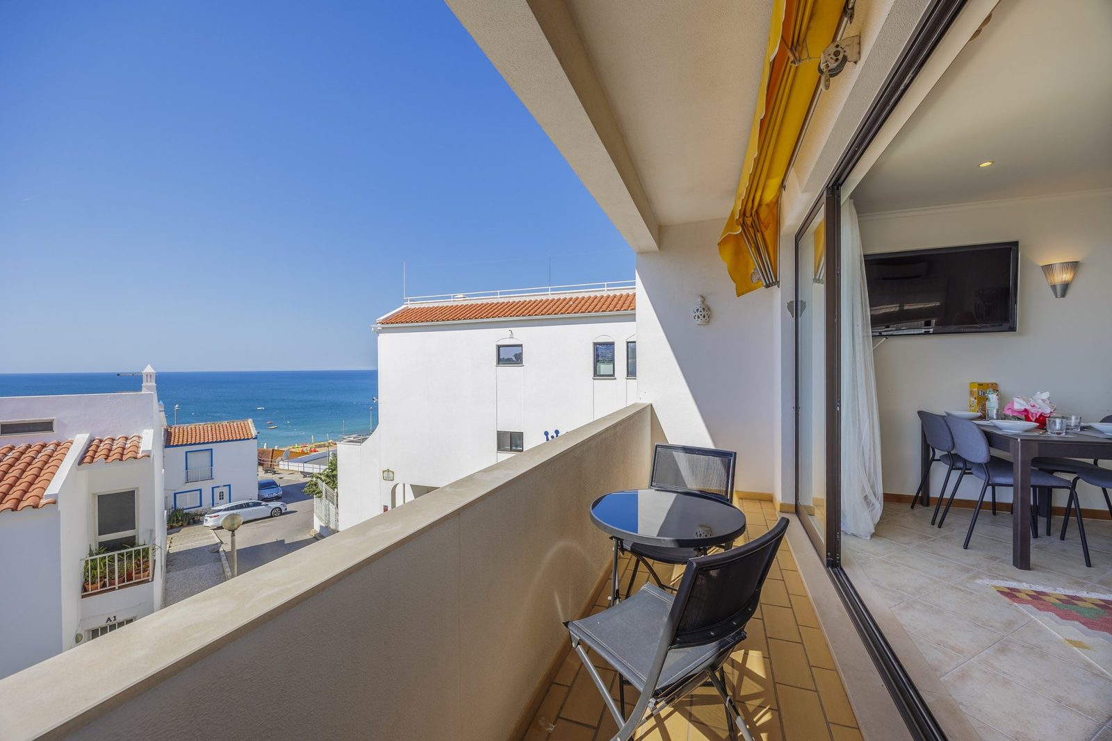 Balcony with table, chairs, and interior view