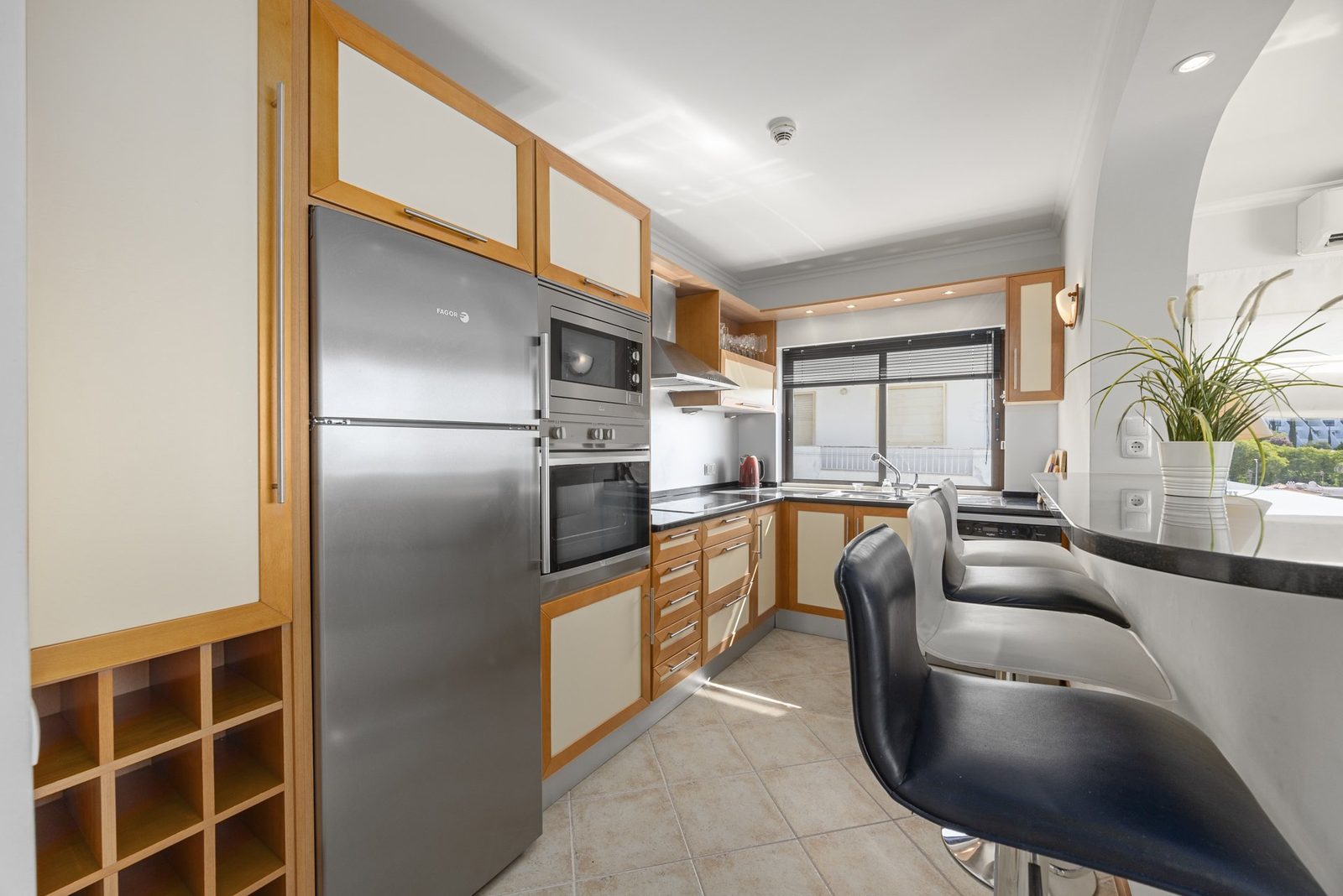 Kitchen with stainless steel appliances and breakfast bar