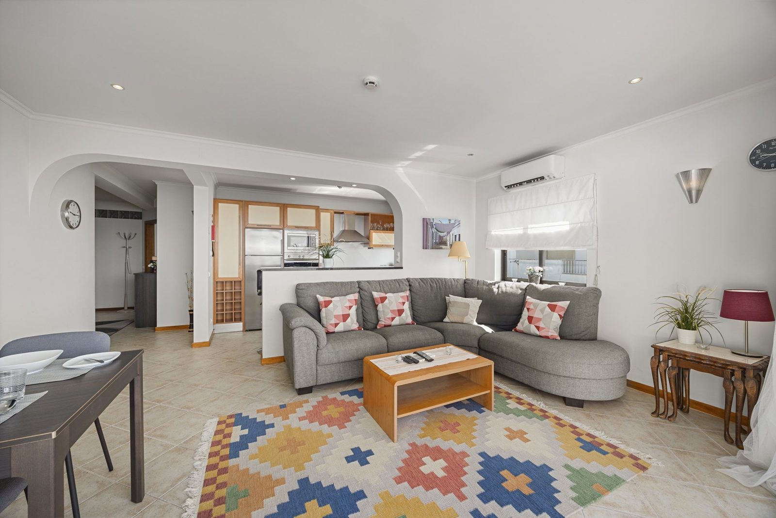 Living room with corner sofa and colourful rug