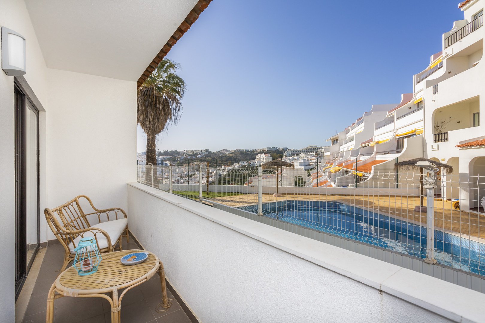 Balcony seating with pool and town view