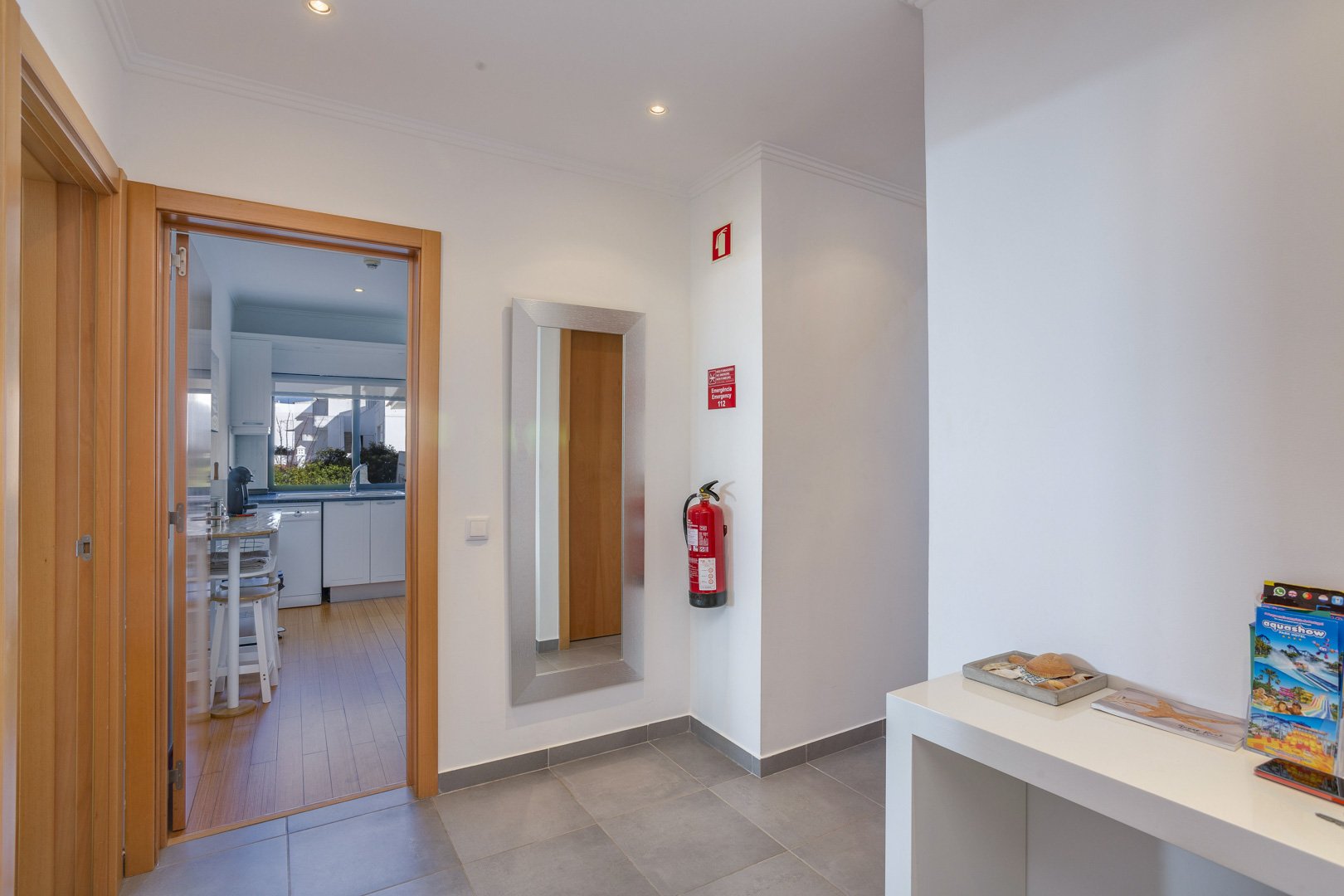 Entrance hallway with full-length mirror leading to the kitchen