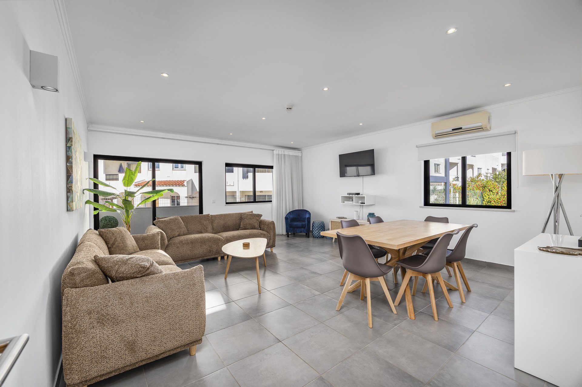 Open-plan living and dining room with balcony access