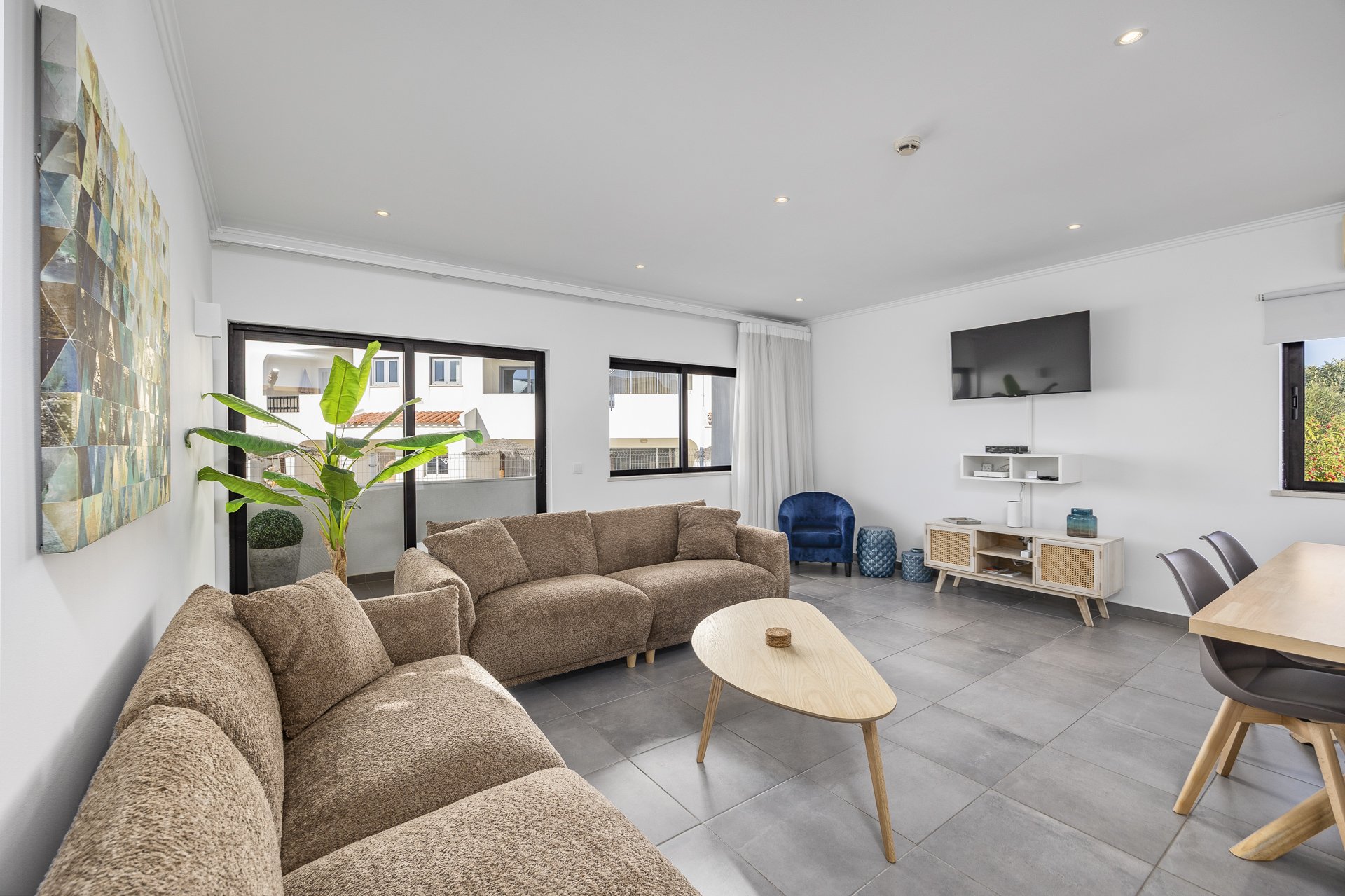 Living room seating area with armchair and TV