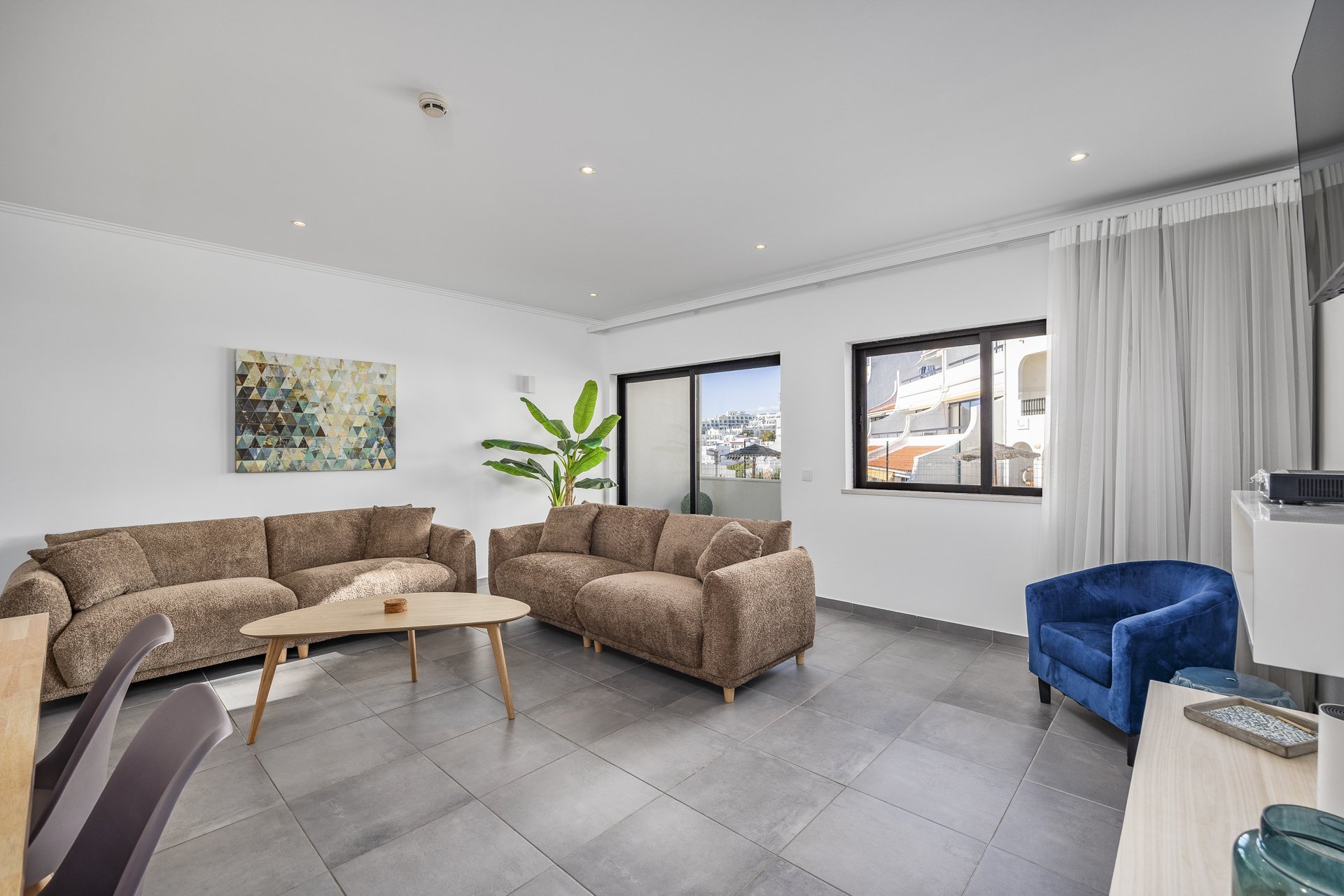 Living room with sectional sofa and wall-mounted TV