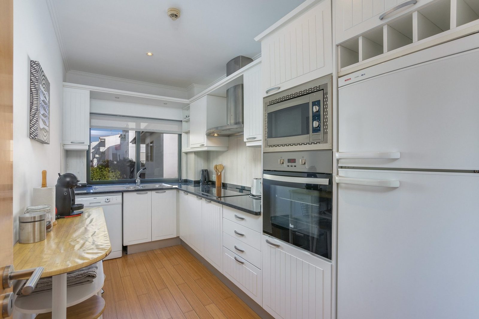 Kitchen with built-in oven, microwave, and fridge freezer