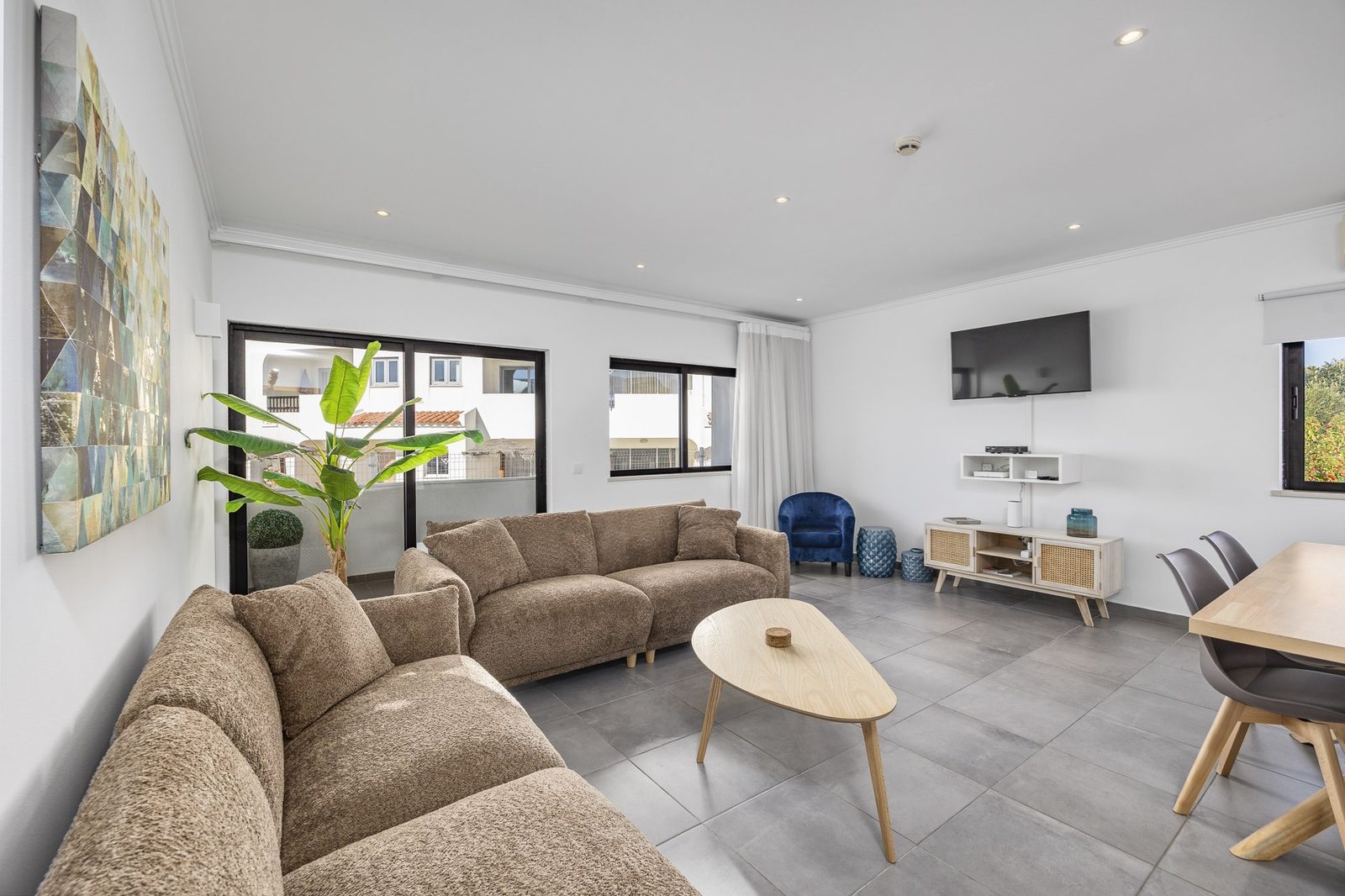 Living room seating area with armchair and TV