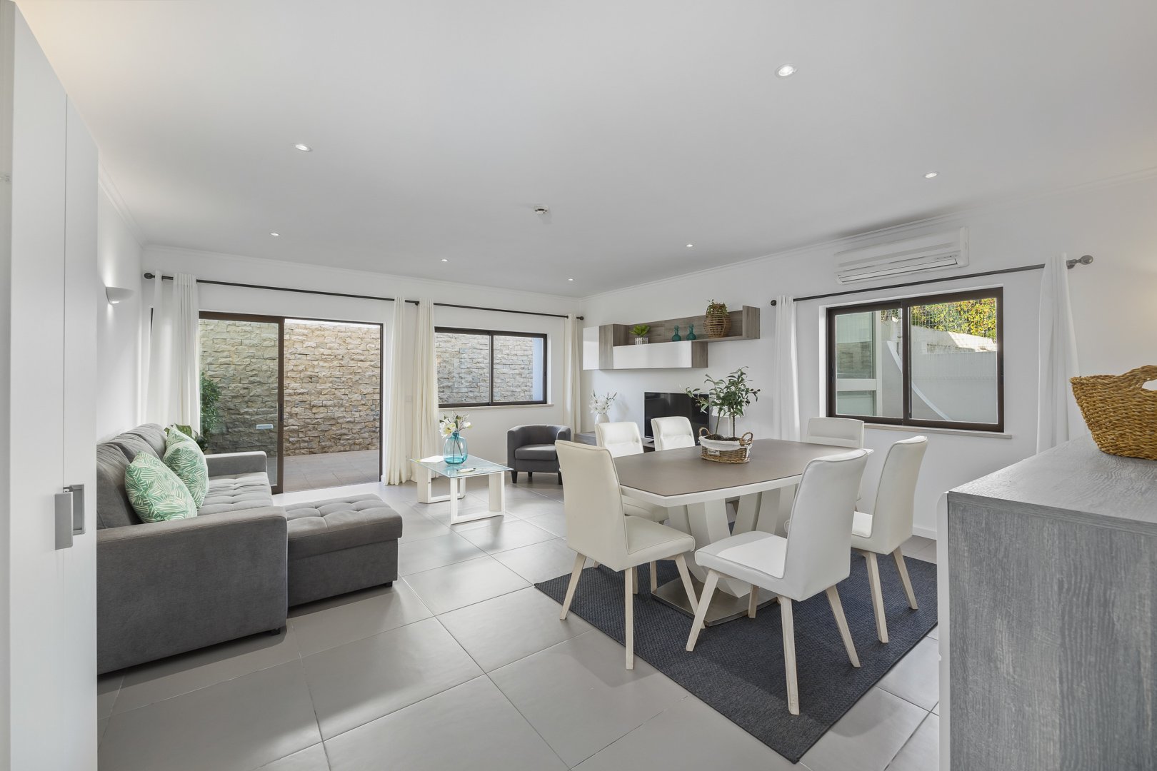 Dining table with sofa and storage cabinet in the open-plan room