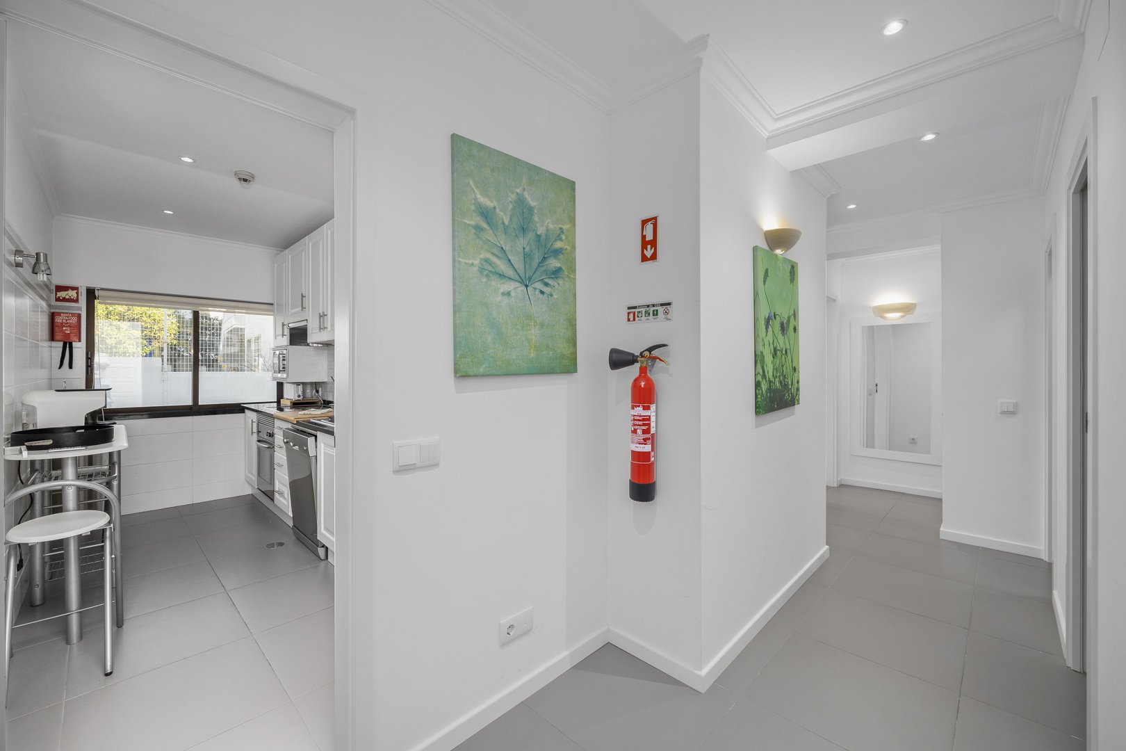 Hallway with kitchen view and wall art