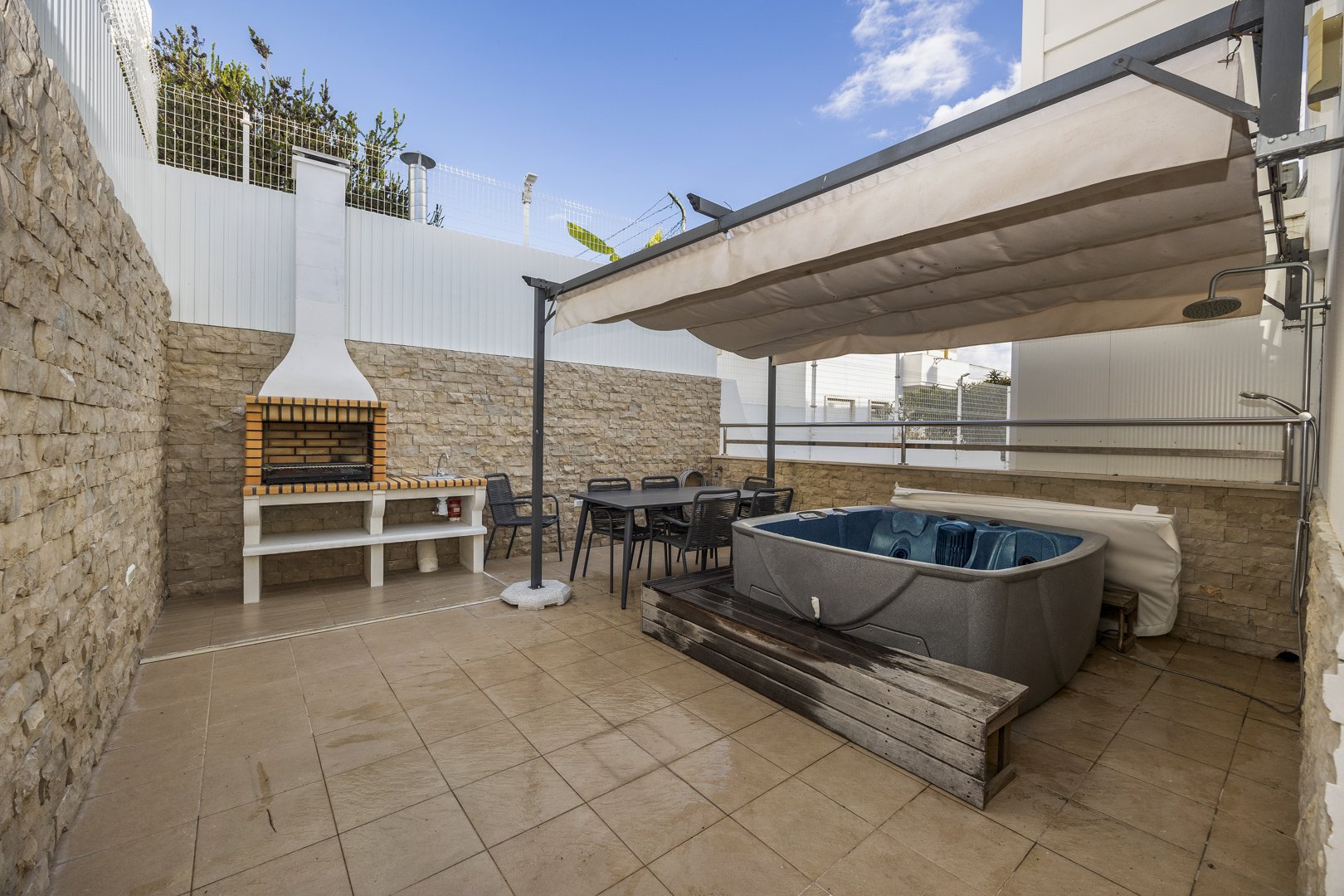 Private terrace with hot tub, barbecue, and dining table