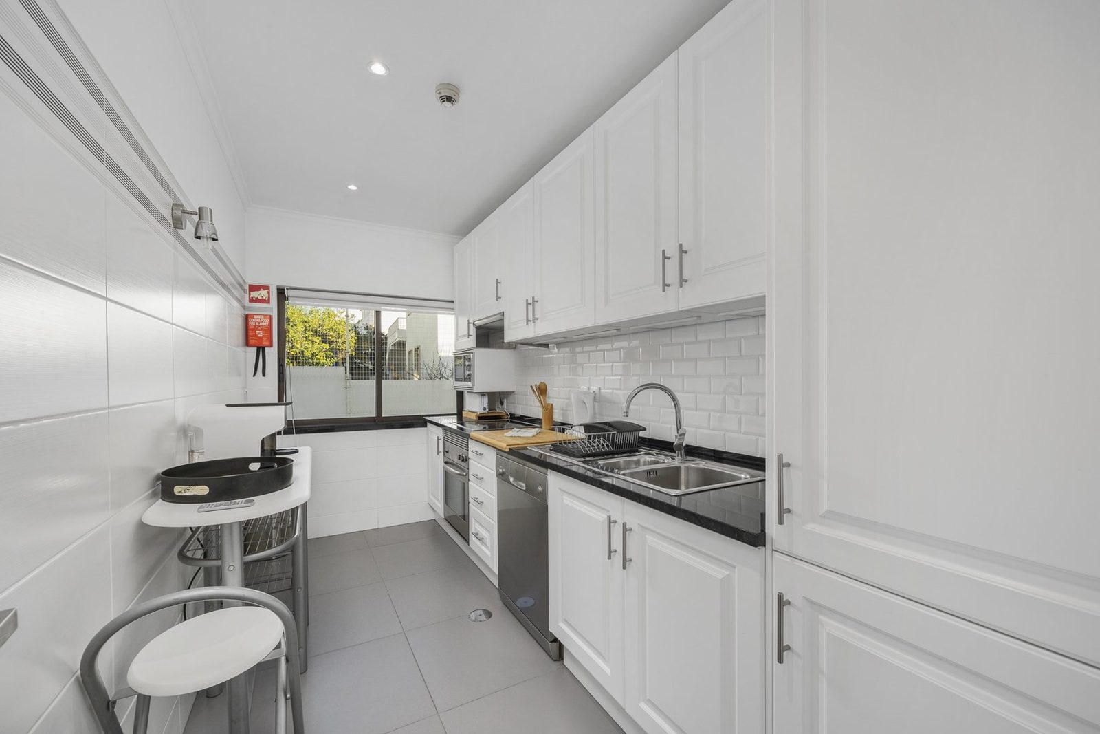 Galley kitchen with white cabinetry
